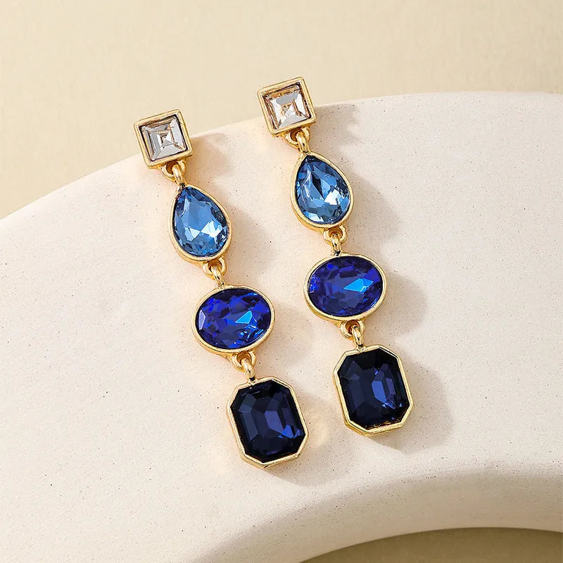 Women's geometric water drop rhinestone ear studs in royal blue alloy with silver tone setting