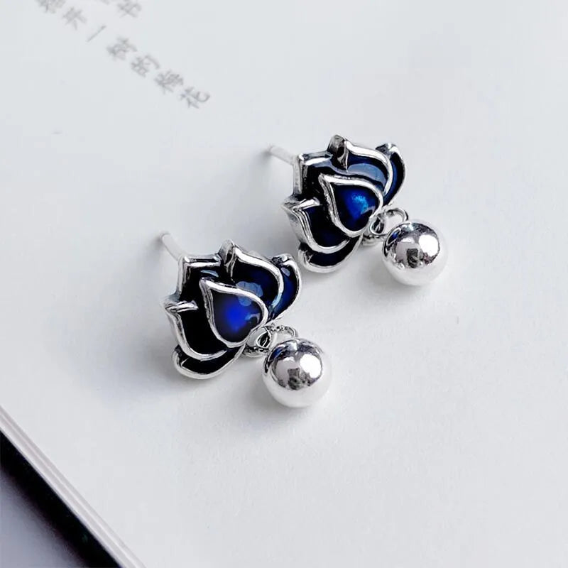 Blue Lotus alloy earrings with flower shape and lotus seedpod tassel detailing