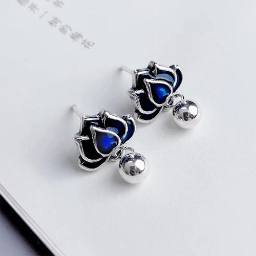 Blue Lotus alloy earrings with flower shape and lotus seedpod tassel detailing