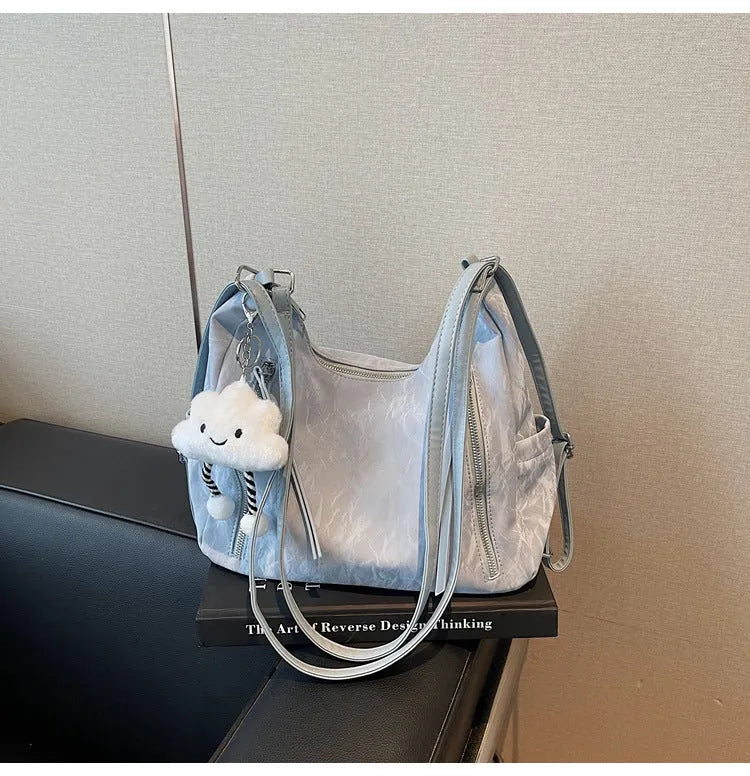 Women's soft PU fashion backpack in blue colour with pendant accessory attached