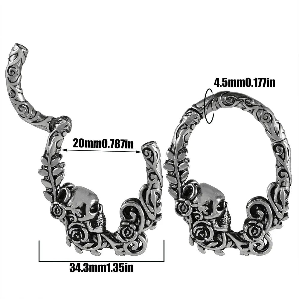 A pair of silver-toned fashion earrings with a geometric totem pattern design on a white background.