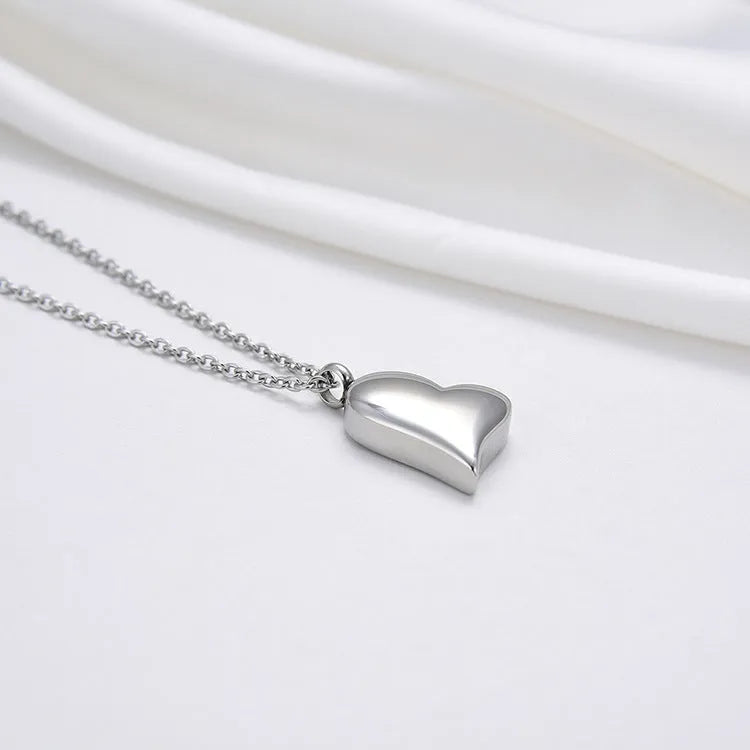 Curved peach heart stainless steel pendant necklace with silver electroplated finish and extension chain