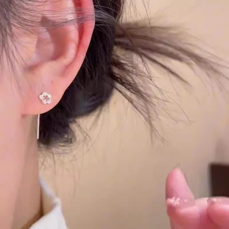 Sterling silver needle hollow flower hanging earrings with silver petal stud design