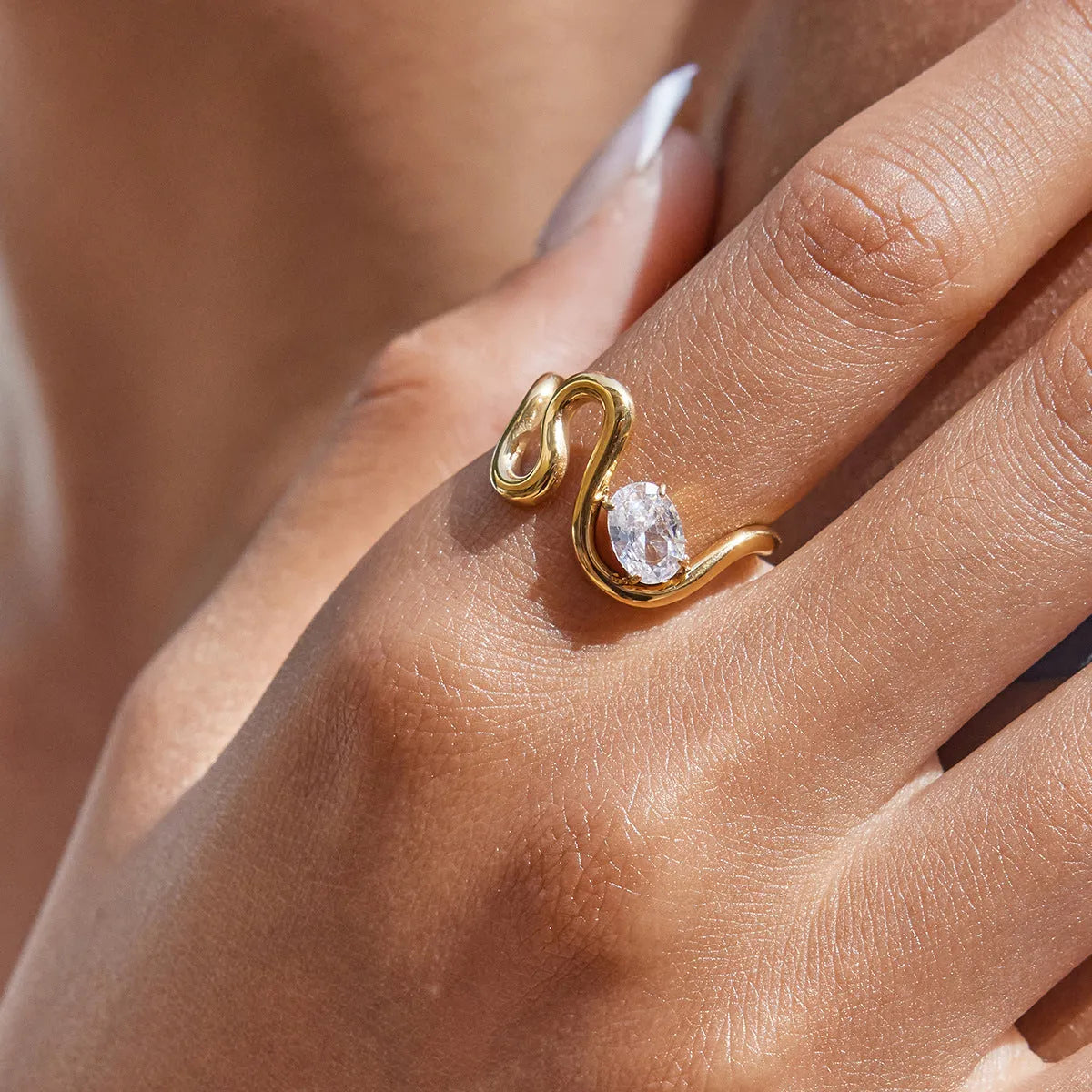 Geometric stainless steel zircon ring with no-fade finish on a hand.