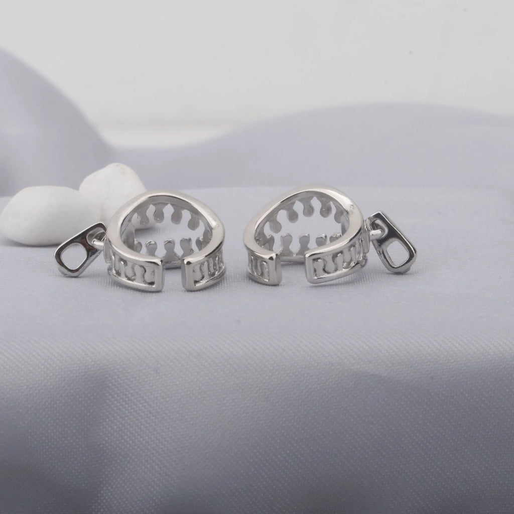A pair of geometric copper clip-on earrings with linear design in colour ES862.