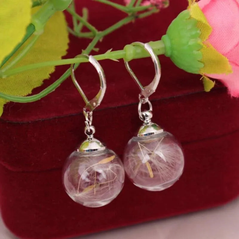 Transparent glass ball earrings with dandelion seed design on silver French hooks