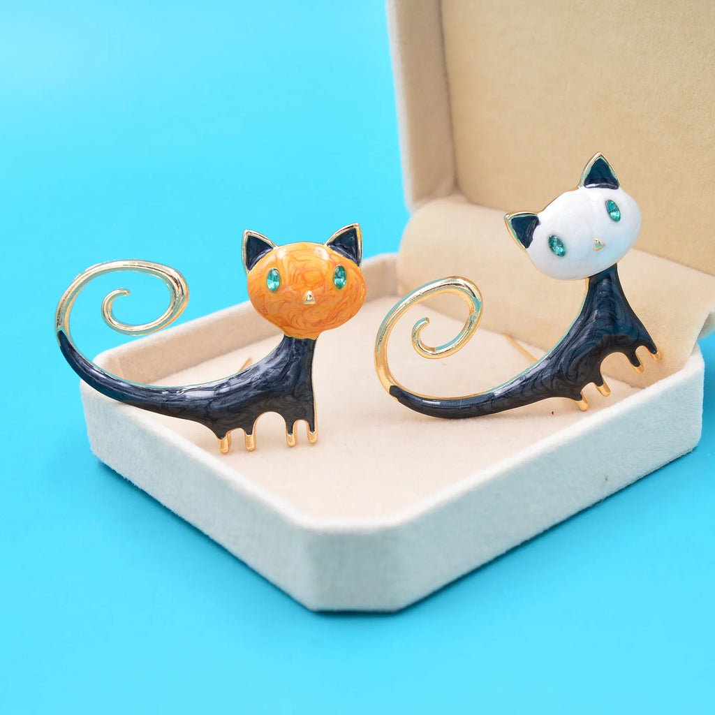 Personalised white and orange alloy cat brooch with painted detailing and a long tail.
