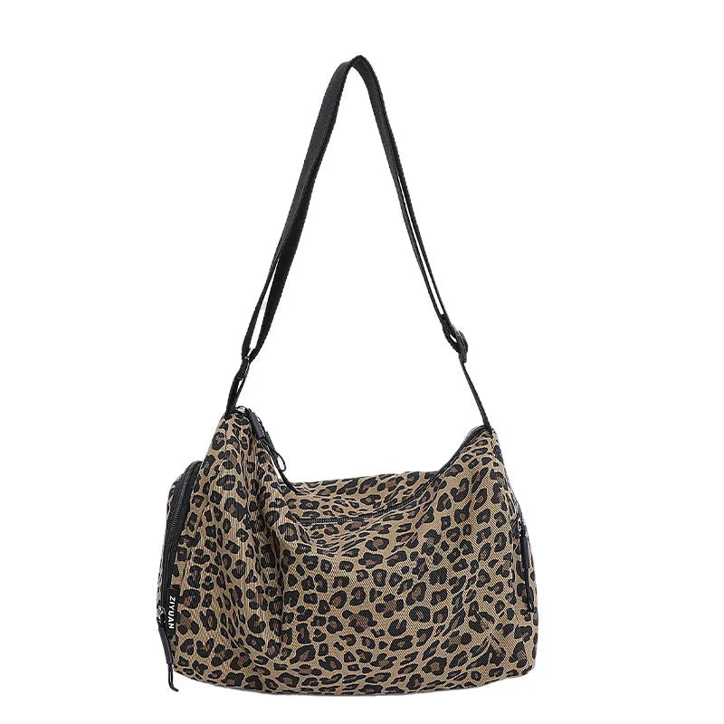 Sports style shoulder messenger bag in leopard print pattern with cross-body strap