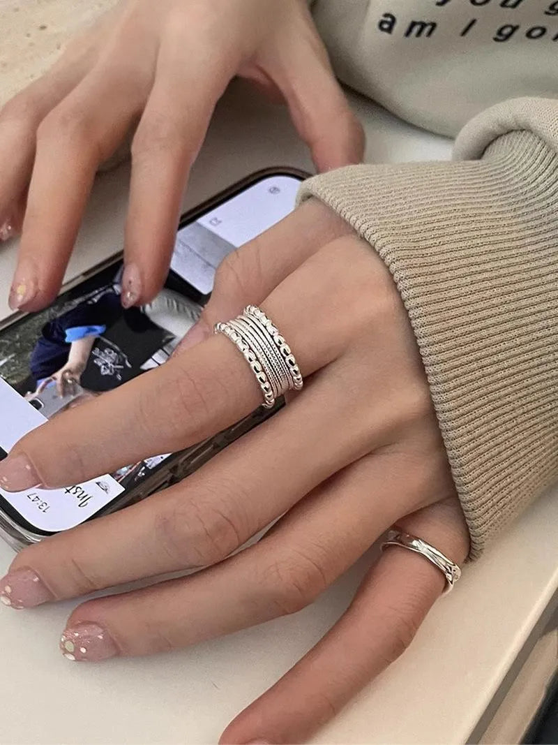 Copper alloy adjustable opening ring with woven twisted multilayer geometry design