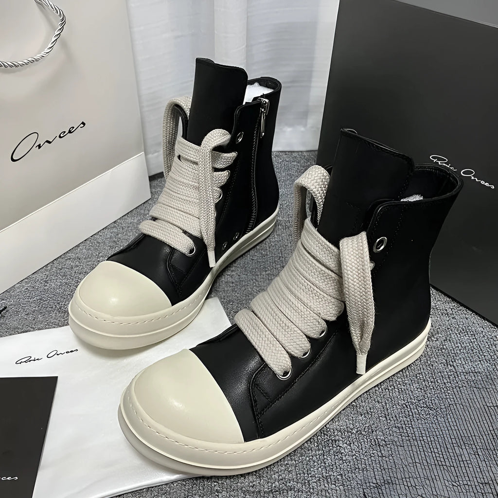Genuine leather high-top sneakers with side zipper in black, shown on a casual outfit.