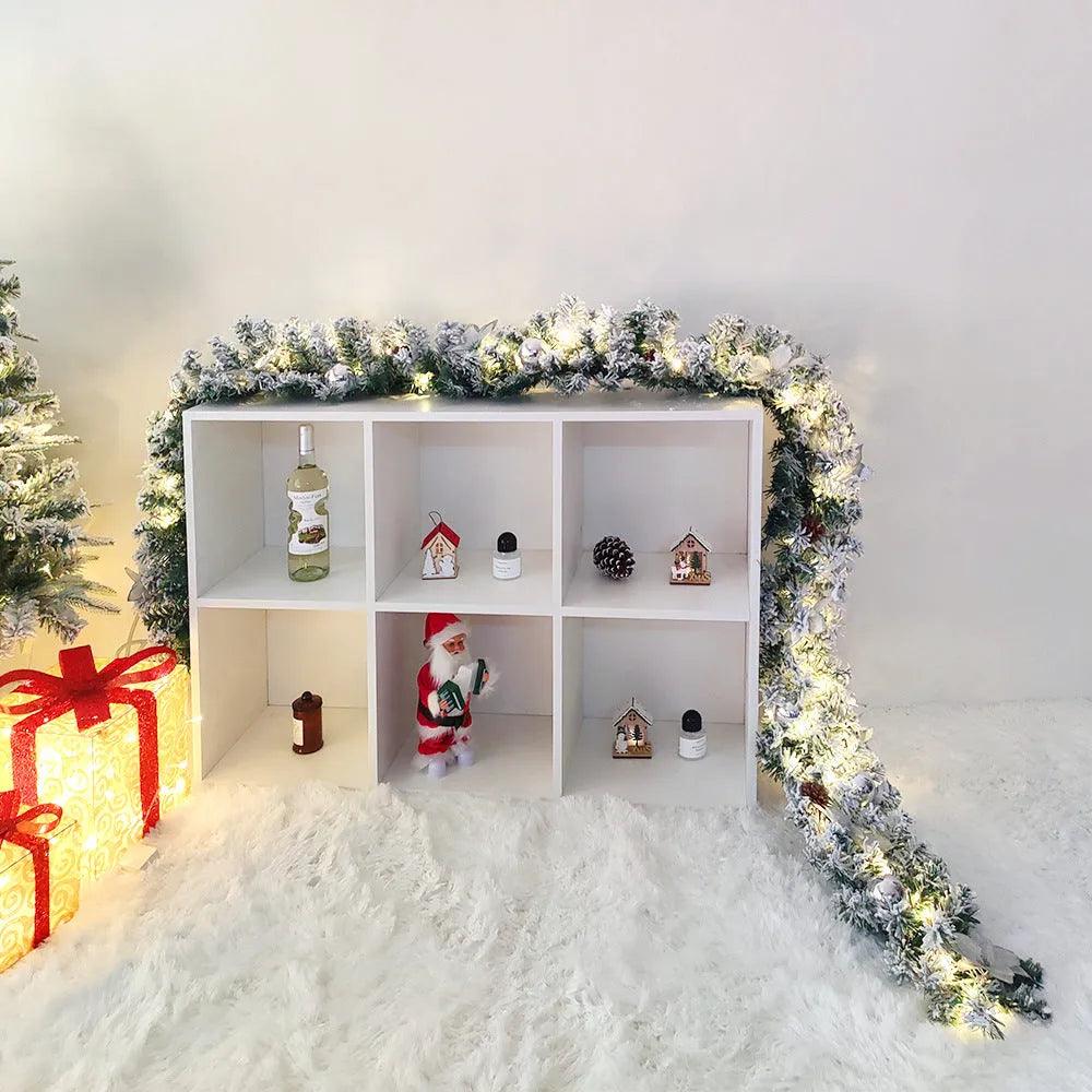 Christmas rattan garland decoration with flocked texture in five colour options displayed draped