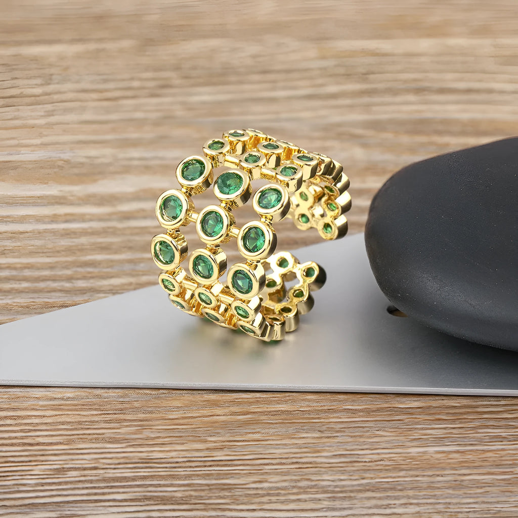 Wide copper ring with green zircon stones and gold plating