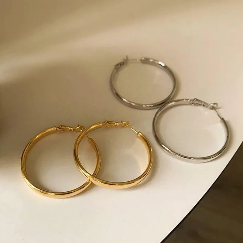 Circular 40mm diameter metal earrings with gold or silver electroplated finish
