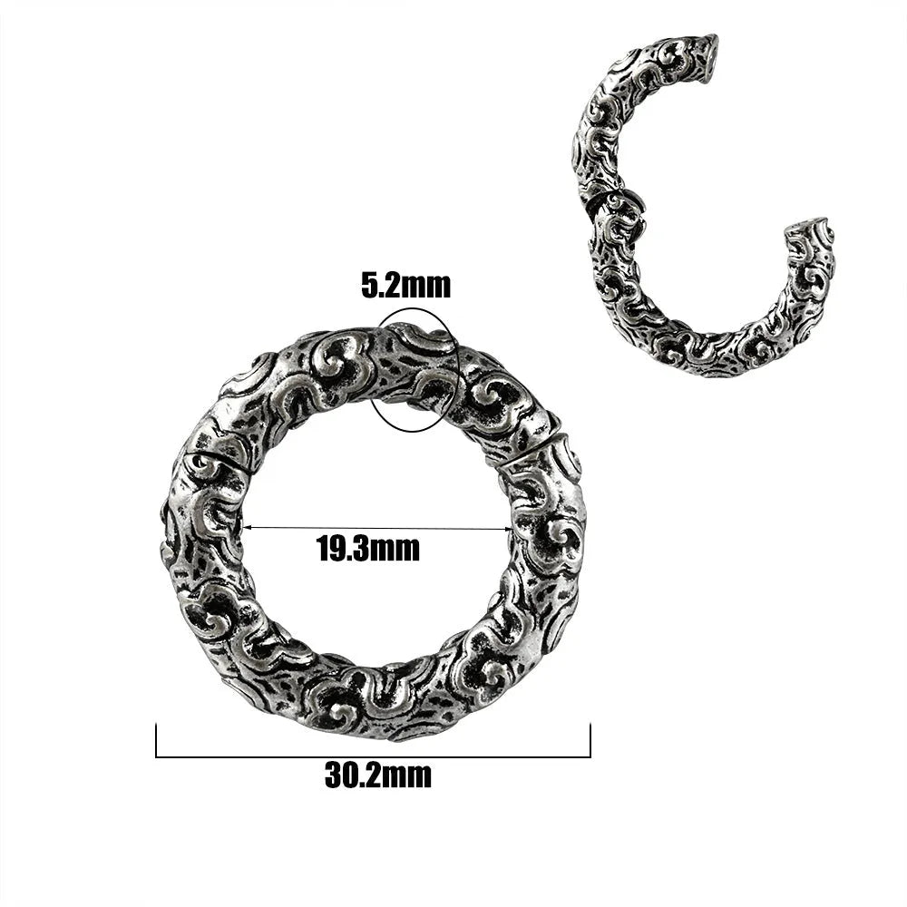 A pair of silver-toned fashion earrings with a geometric totem pattern design on a white background.