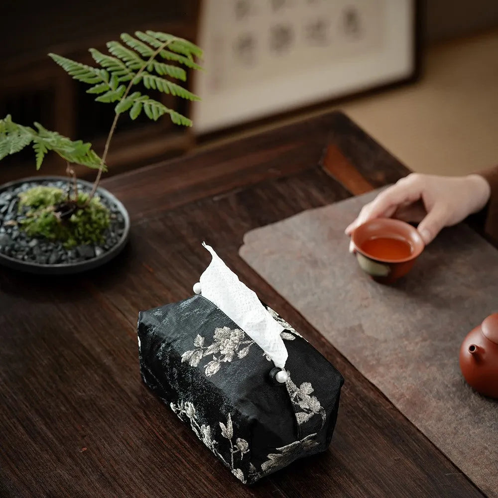 Chinese brocade fabric tissue box with embroidered white plum pattern, approximately 17 cm wide
