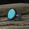 Men's round turquoise ring with antique silver alloy finish showing simple stone setting