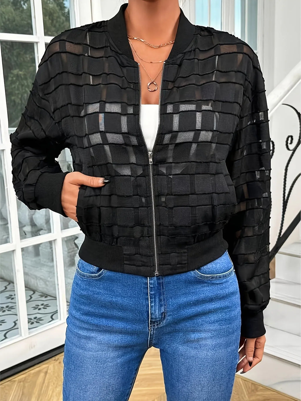 Black women's casual jacket with geometric pattern, semi-transparent fabric, front zipper, and long sleeves.