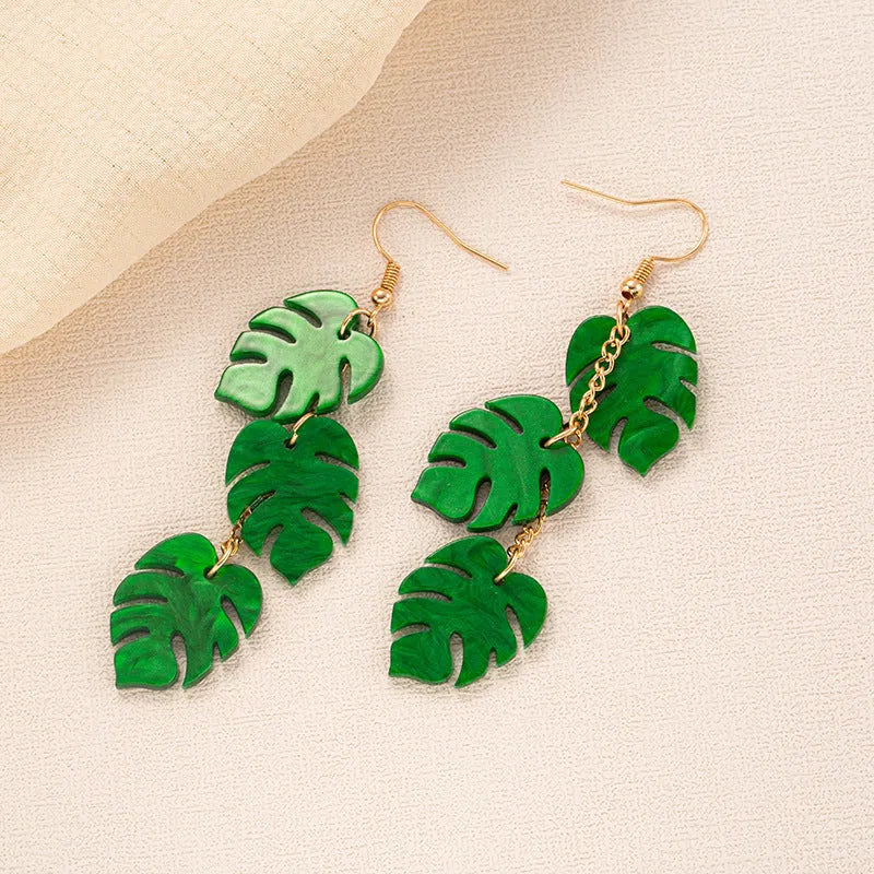 Acrylic drop earrings with a carved coconut and jackfruit design on a metal hook, shown in multiple colour variants.