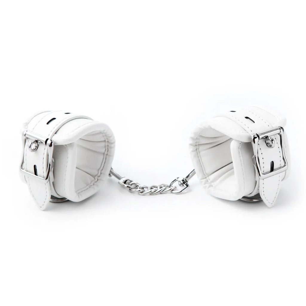 White PU sponge bondage restraint set showing handcuffs, foot cuffs, and neck scarf