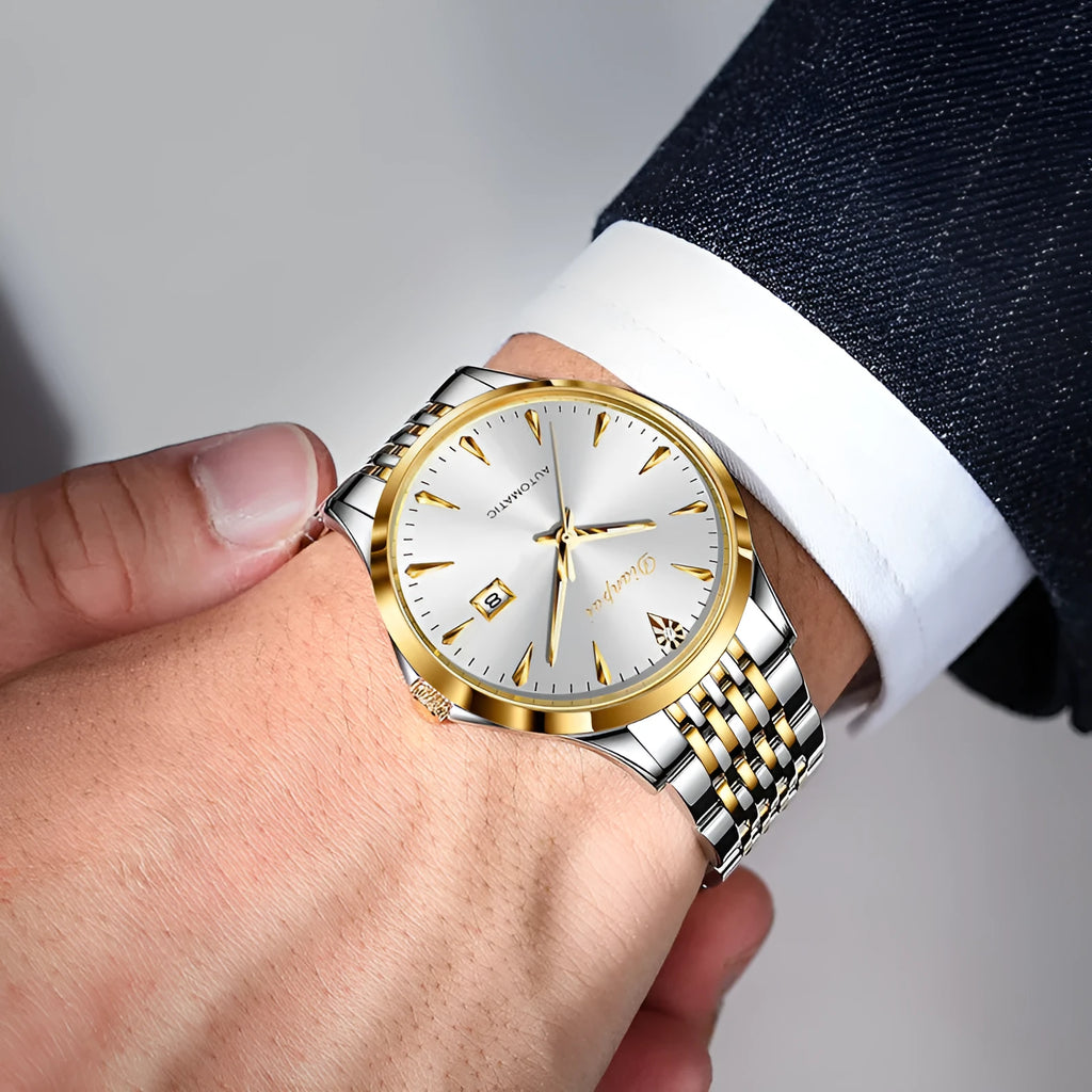 Men's simple dial automatic watch with stainless steel strap on a wrist.