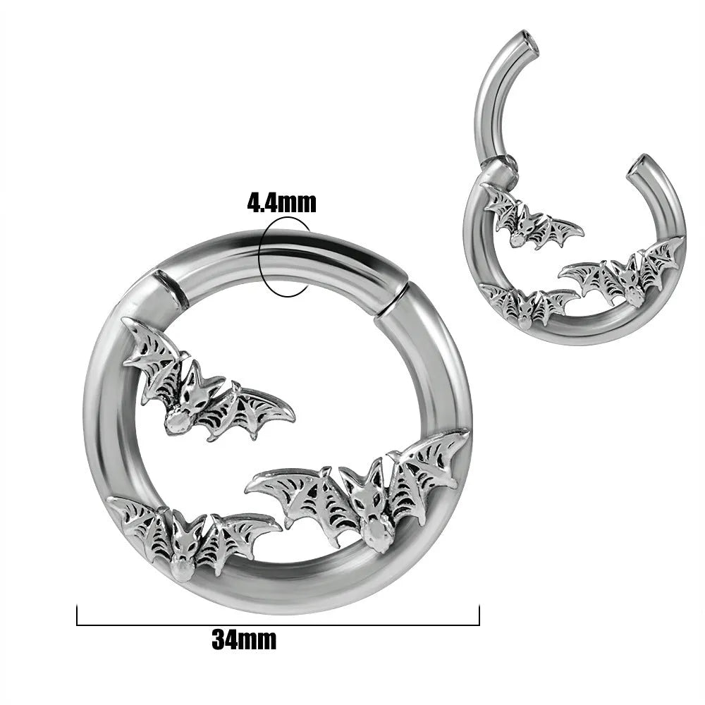 A pair of silver-toned fashion earrings with a geometric totem pattern design on a white background.