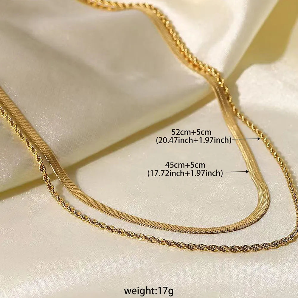 Geometric double-layer twist pendant necklace on an adjustable snake bones chain in a solid colour.