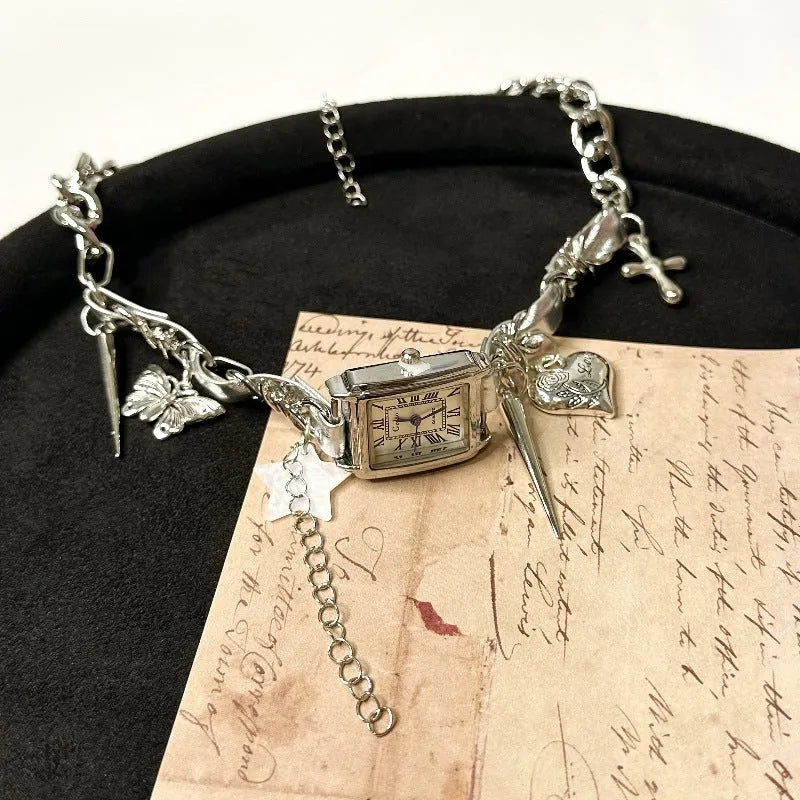 Dark electroplated women's necklace with layered chains, cross pendant, and adjustable length