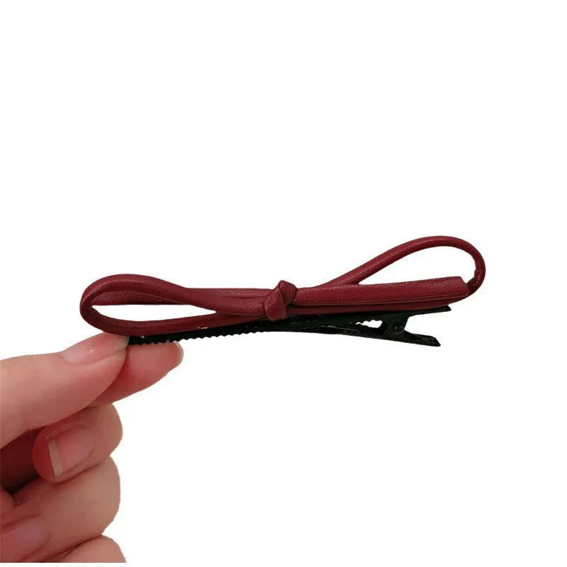 Wine red leather bow barrettes for women with handmade construction and clip mechanism