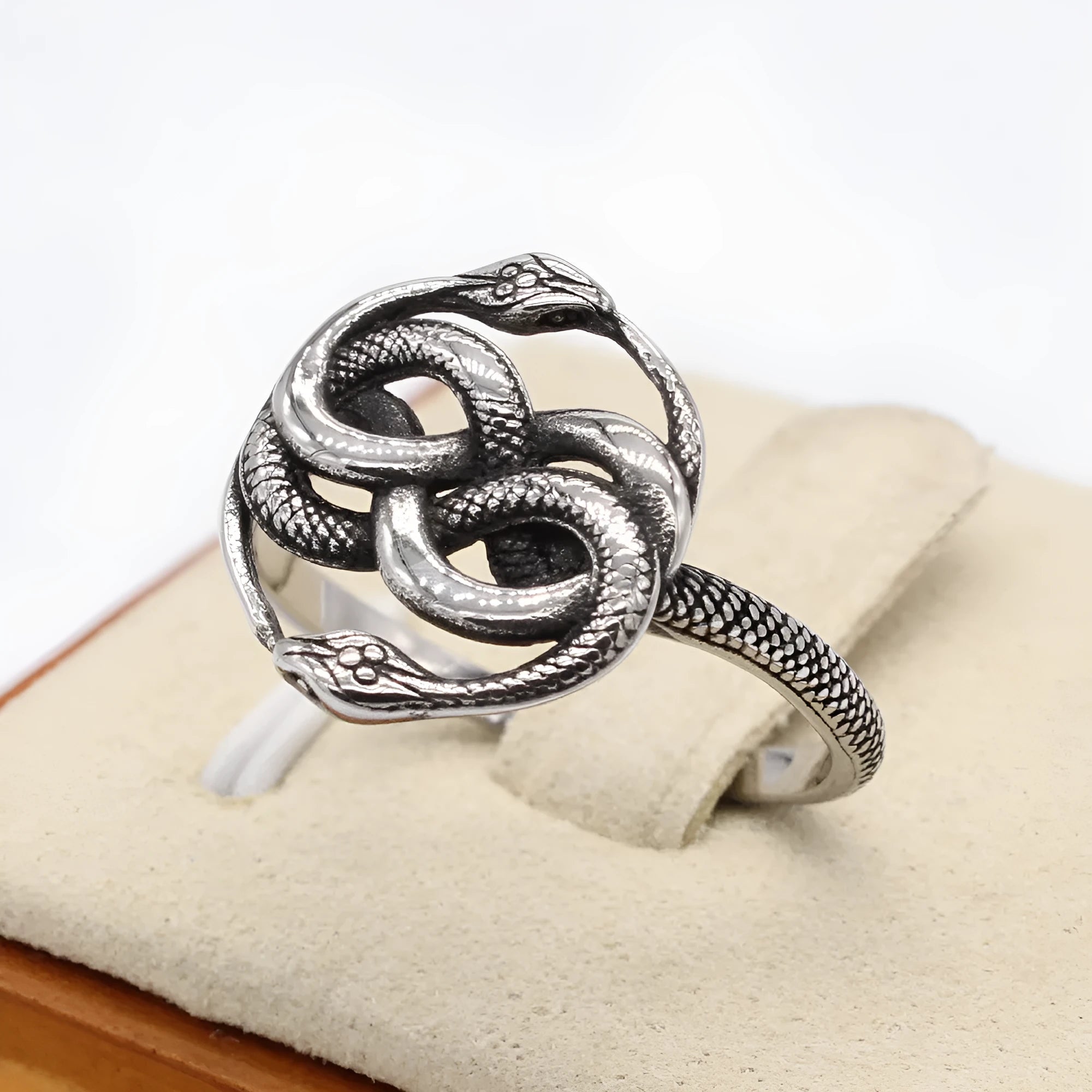 Steel colour titanium steel double snake retro ring on finger showing intricate snake design