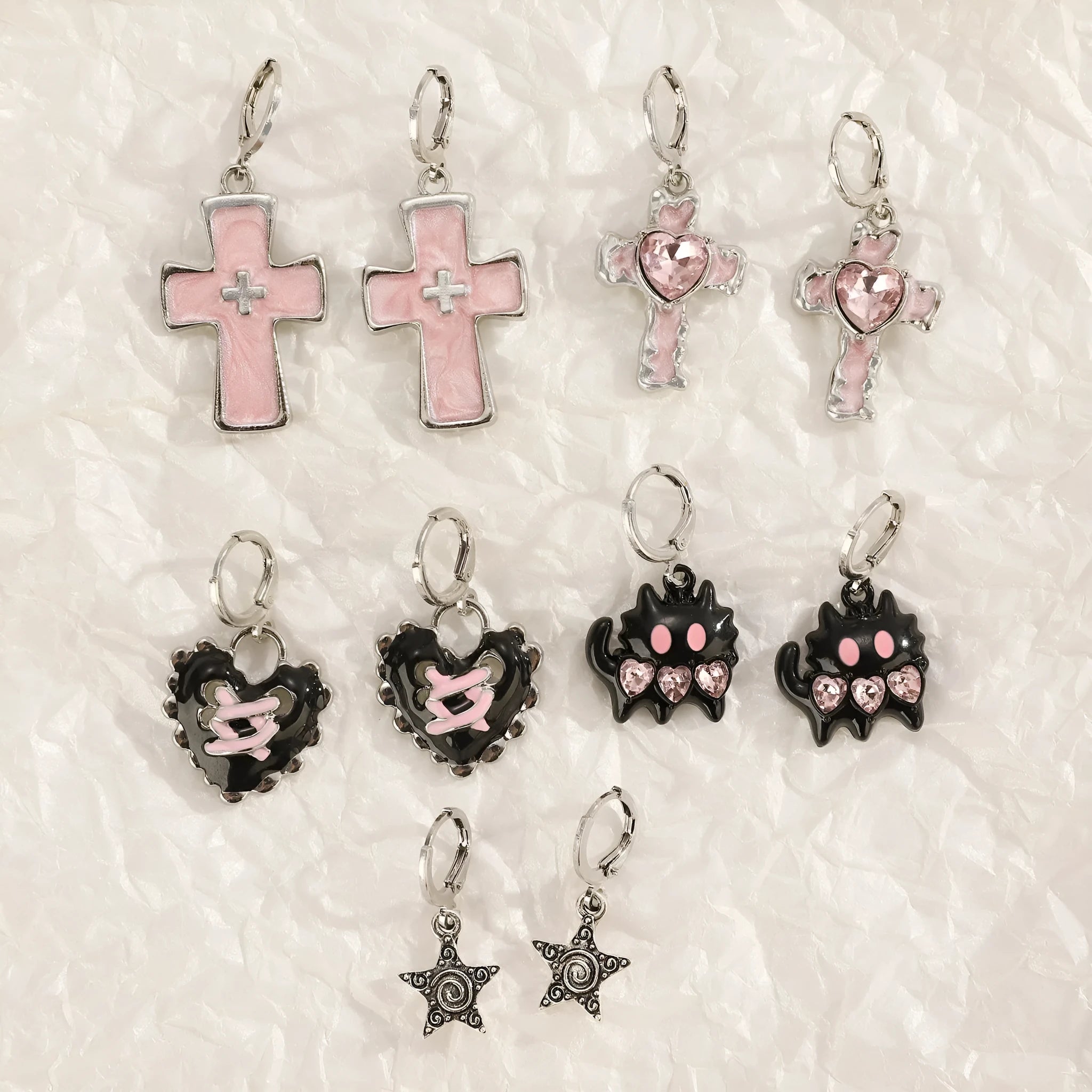 Women's alloy earrings with cross and heart designs in white and antique silver colour variants