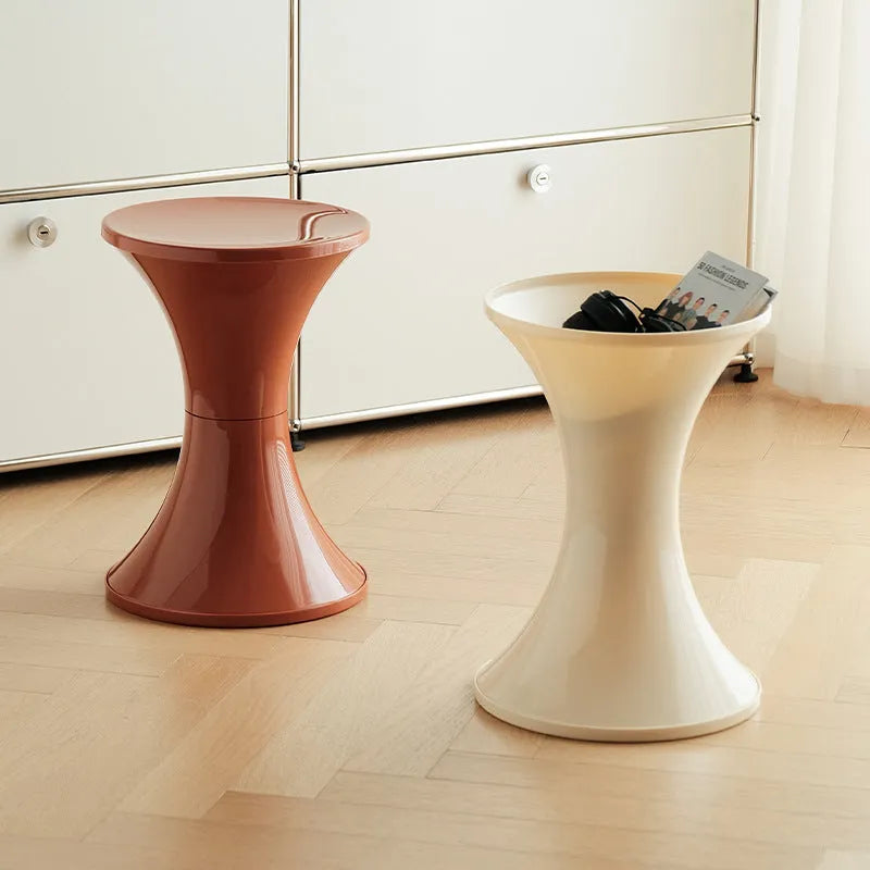 Plastic hourglass-shaped shoe changing stool shown in available colours.
