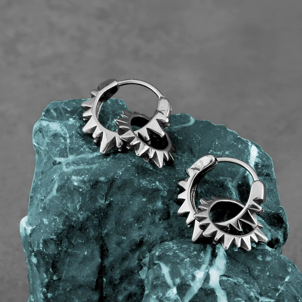 A pair of polished stainless steel round hoop earrings with a titanium steel finish in a steel colour.