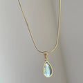 Retro titanium steel necklace with a blue or green water drop pendant featuring a mixed gem inlay.