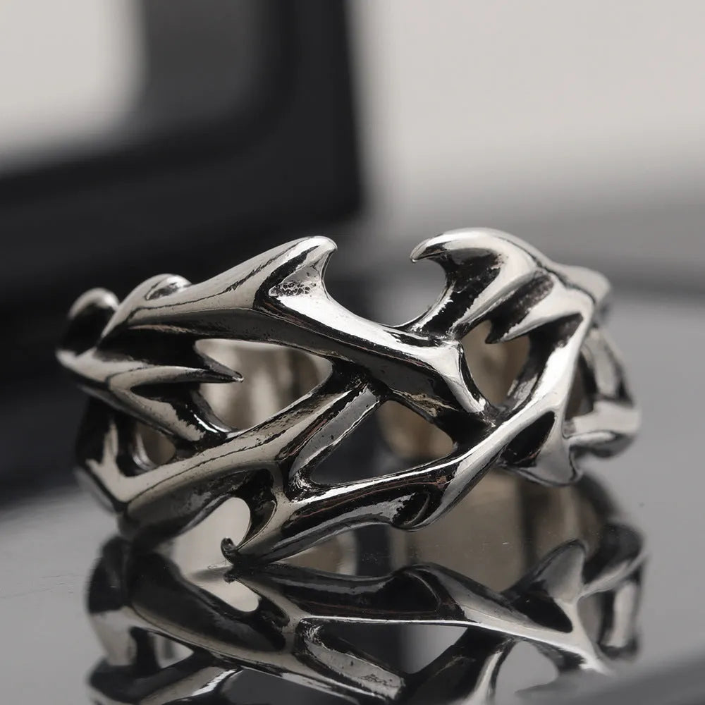 Geometric copper ring with thorn and flower design featuring adjustable opening