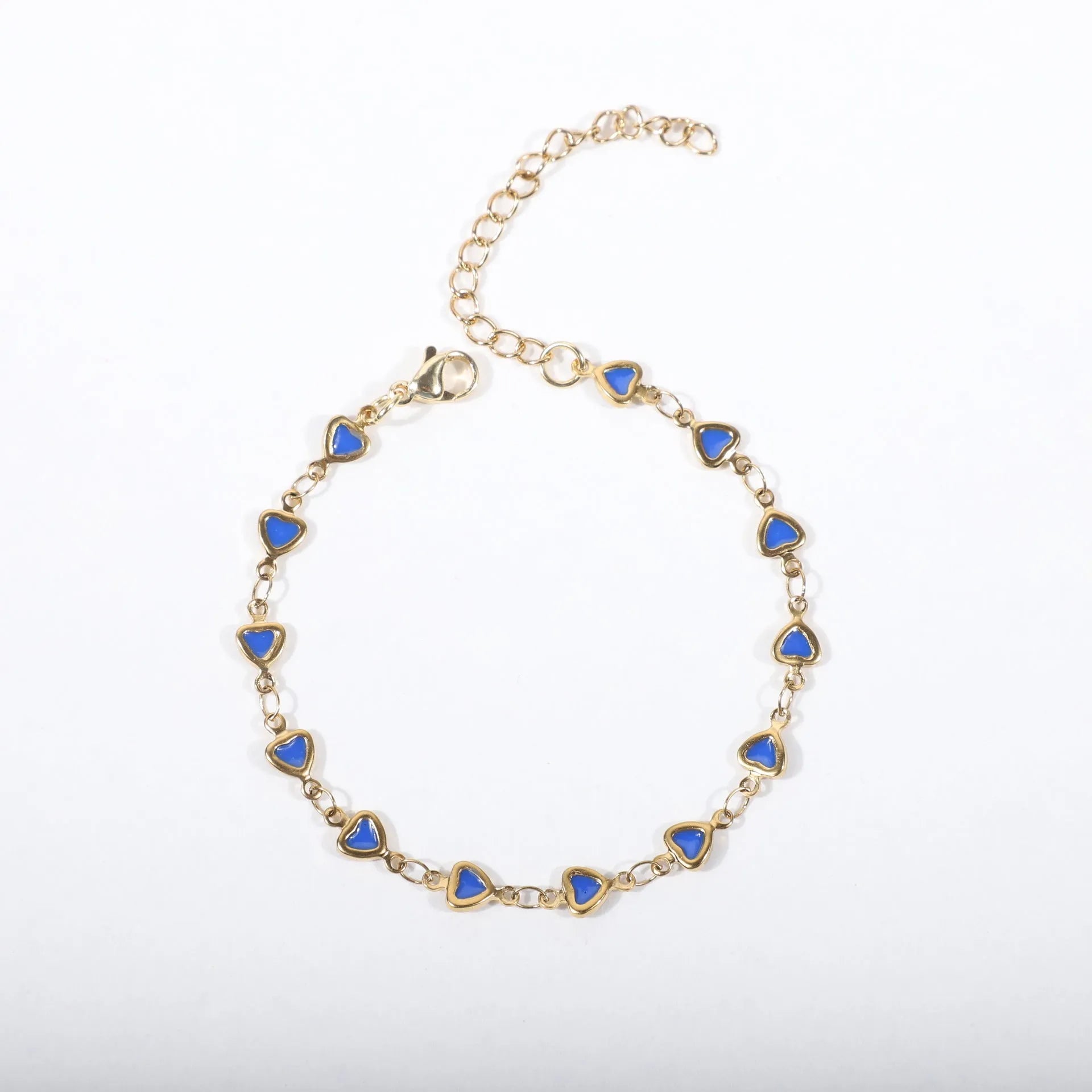 Stainless steel heart-shaped bracelet with gold plating in multiple colour options on a wrist.