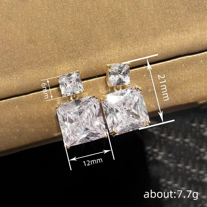 A pair of geometric square design copper earrings for women, shown in white gold and gold colour options.