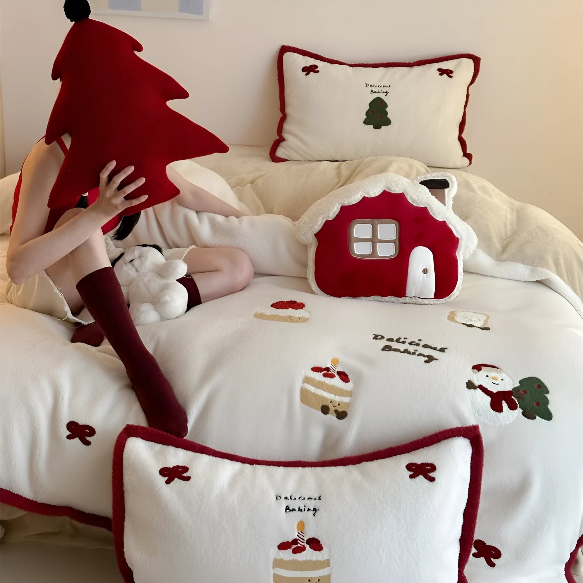 Winter Christmas cartoon patterned bed linen four-piece set on a bed, showing duvet cover and pillowcases.