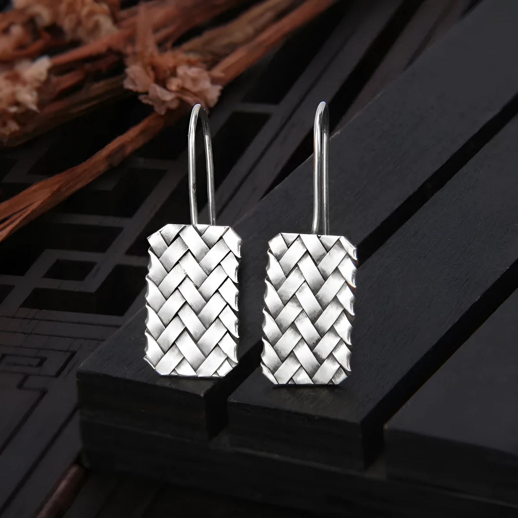 Silver geometric diamond-shaped earrings with a woven plaid pattern for women.