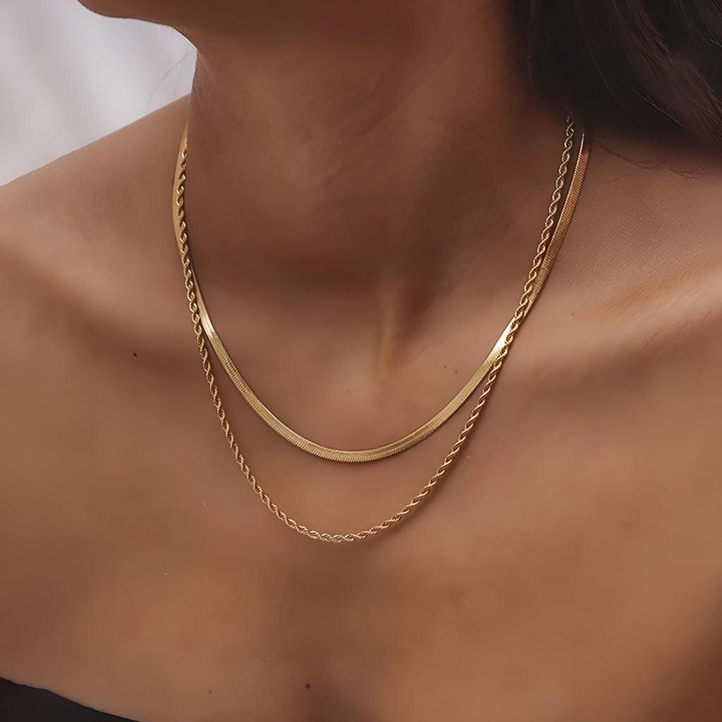 Geometric double-layer twist pendant necklace on an adjustable snake bones chain in a solid colour.