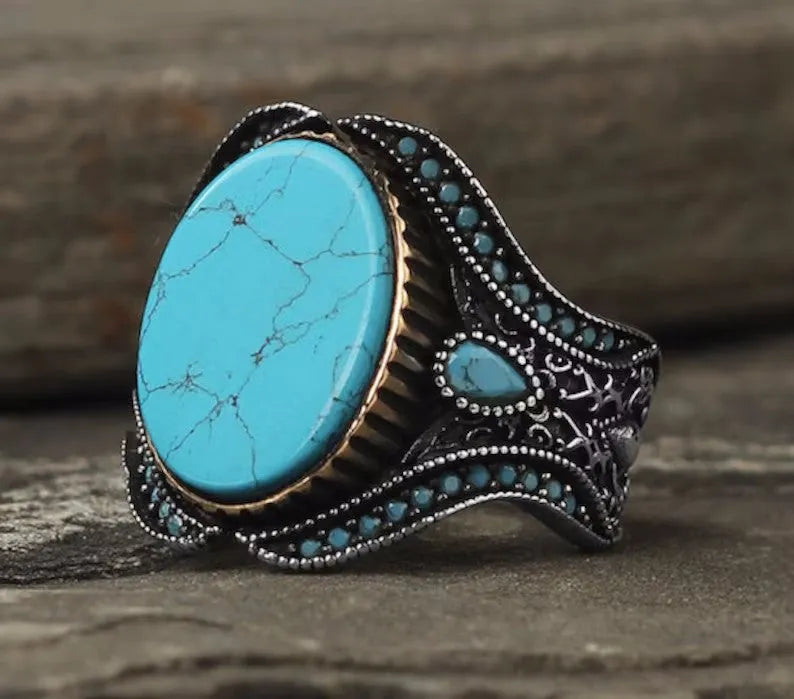 Men's round turquoise ring with antique silver alloy finish showing simple stone setting