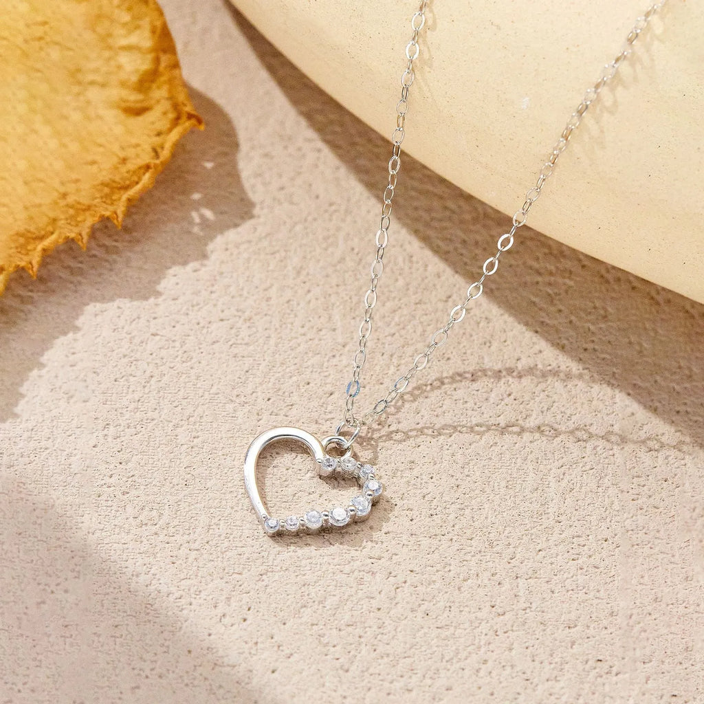 S925 sterling silver hollow heart pendant necklace on a regular chain, available in white gold or 18K gold finish.