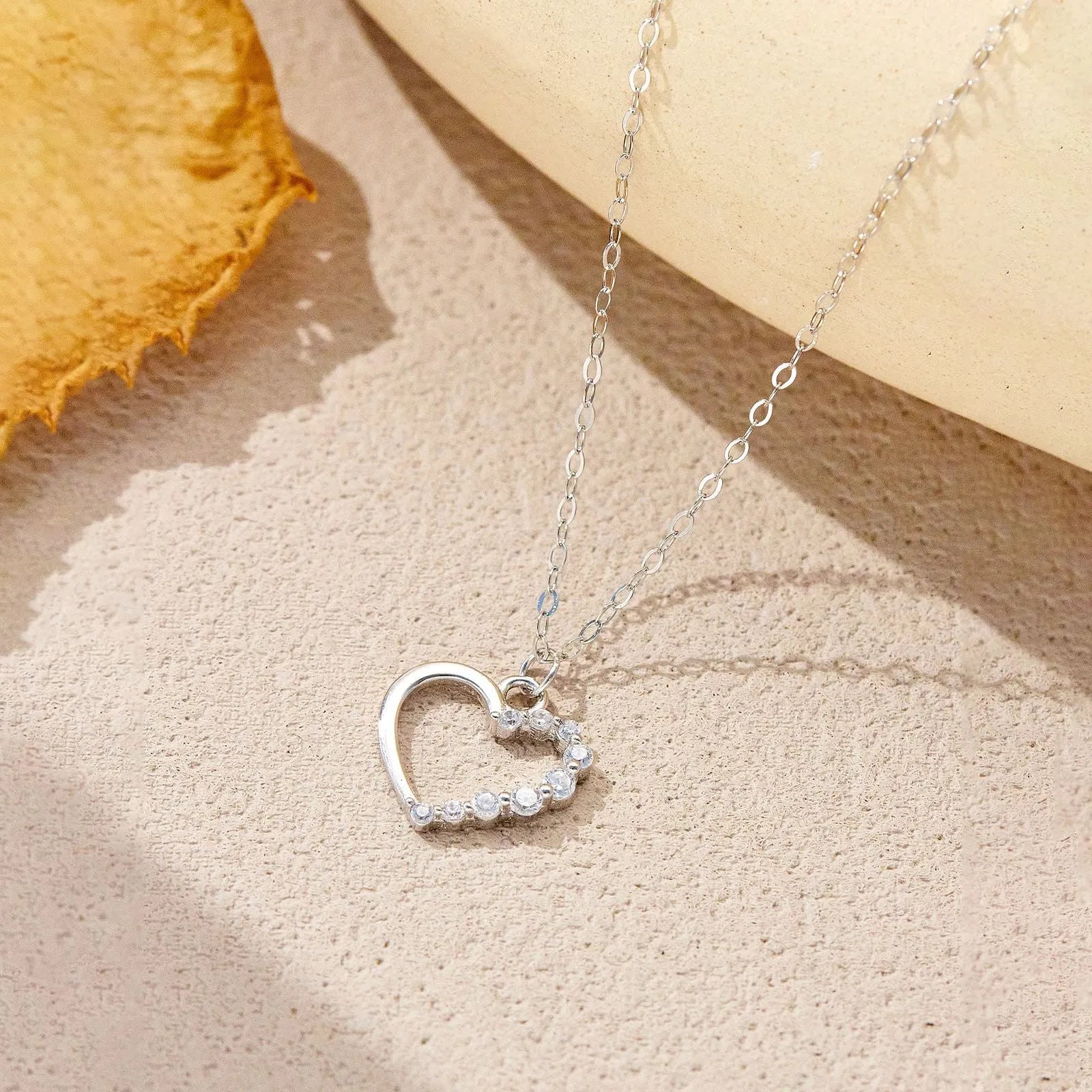 S925 sterling silver hollow heart pendant necklace on a regular chain, available in white gold or 18K gold finish.