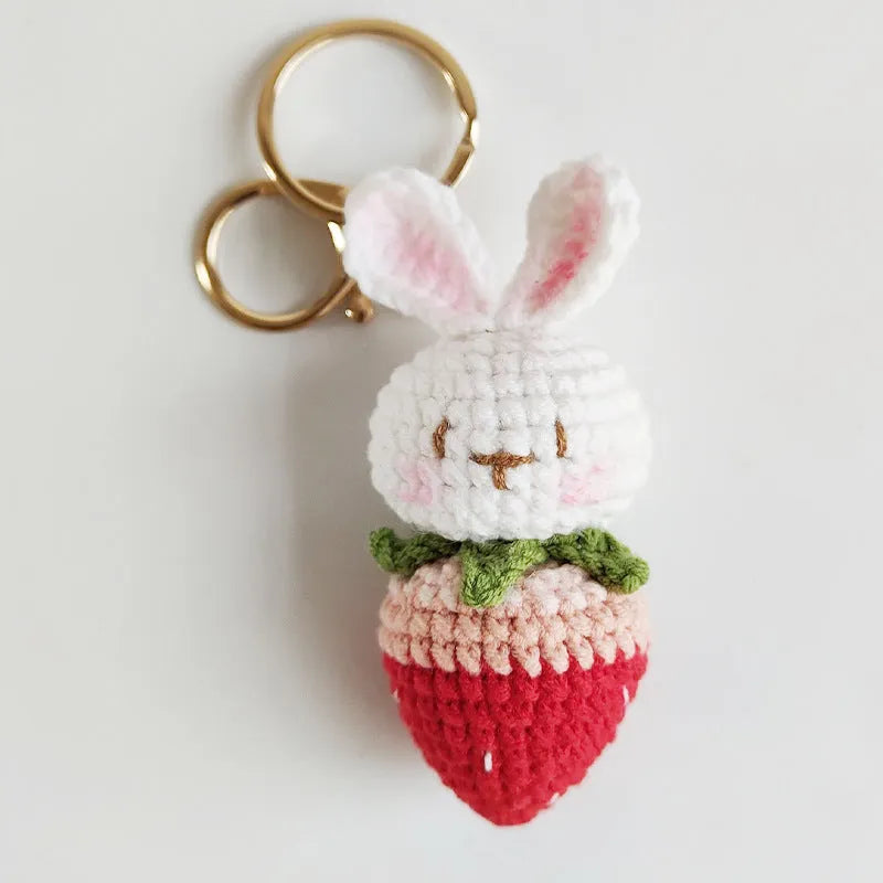 White hand-woven wire pendant with a rabbit strawberry cartoon design and a key loop.
