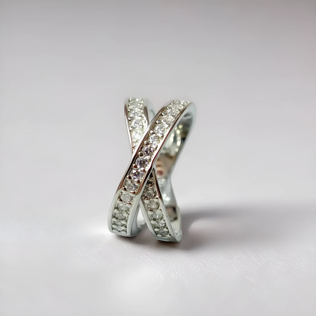 Simple geometric copper cross ring with micro-inlaid zircon stones in silver or rose gold finish.
