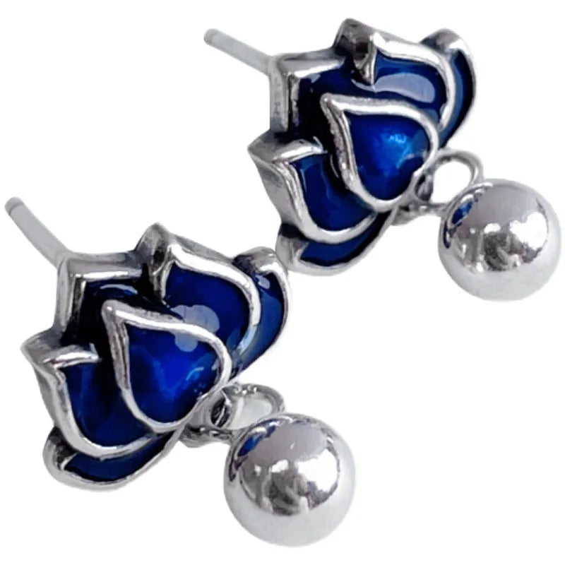Blue Lotus alloy earrings with flower shape and lotus seedpod tassel detailing