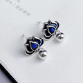 Blue Lotus alloy earrings with flower shape and lotus seedpod tassel detailing