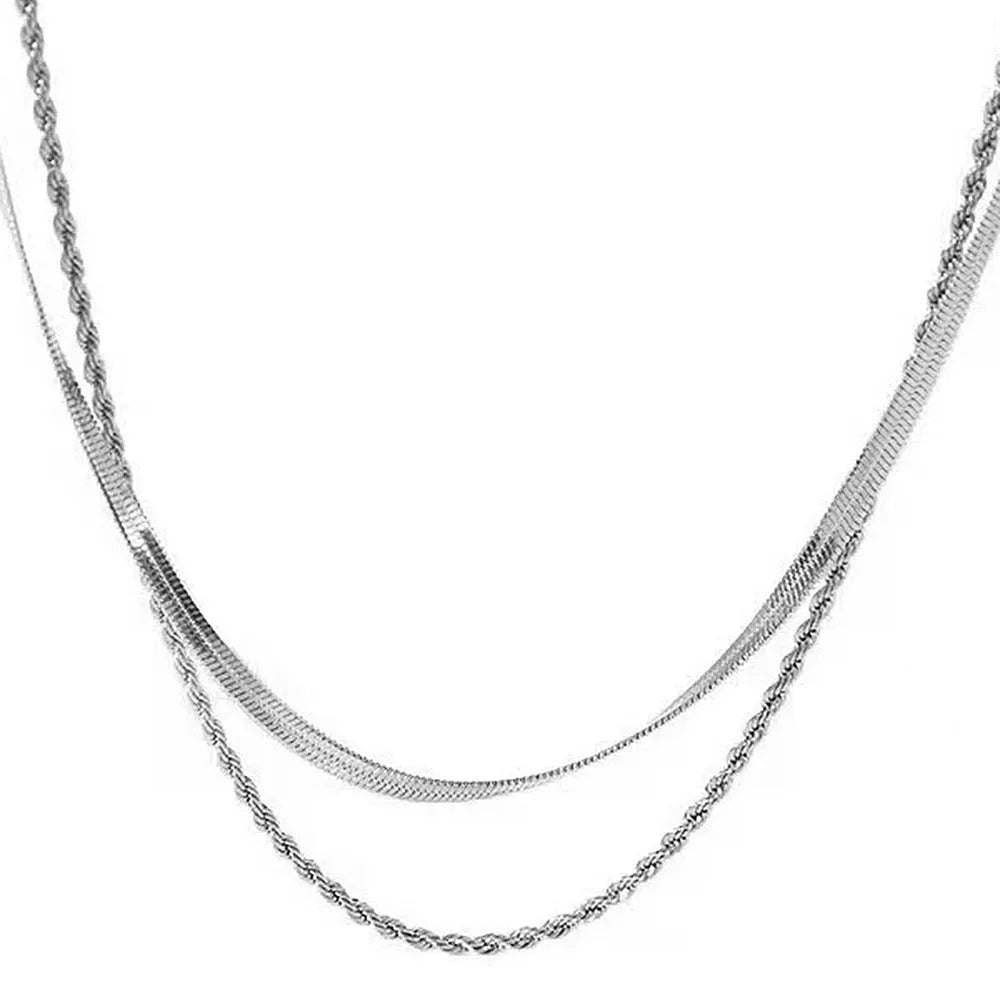 Geometric double-layer twist pendant necklace on an adjustable snake bones chain in a solid colour.