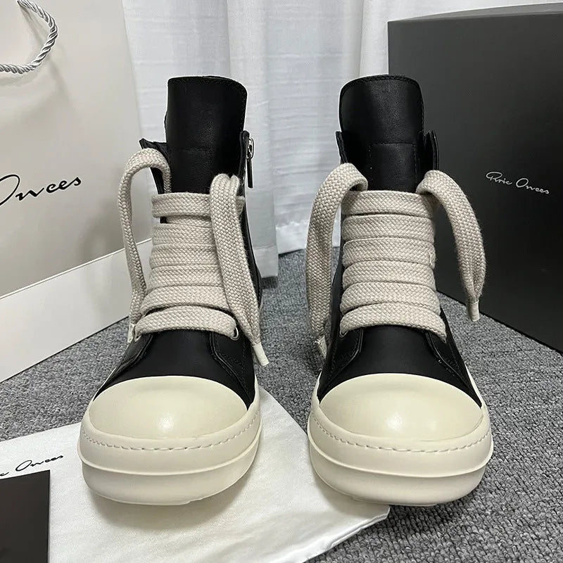Genuine leather high-top sneakers with side zipper in black, shown on a casual outfit.