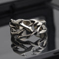 Geometric copper ring with thorn and flower design featuring adjustable opening