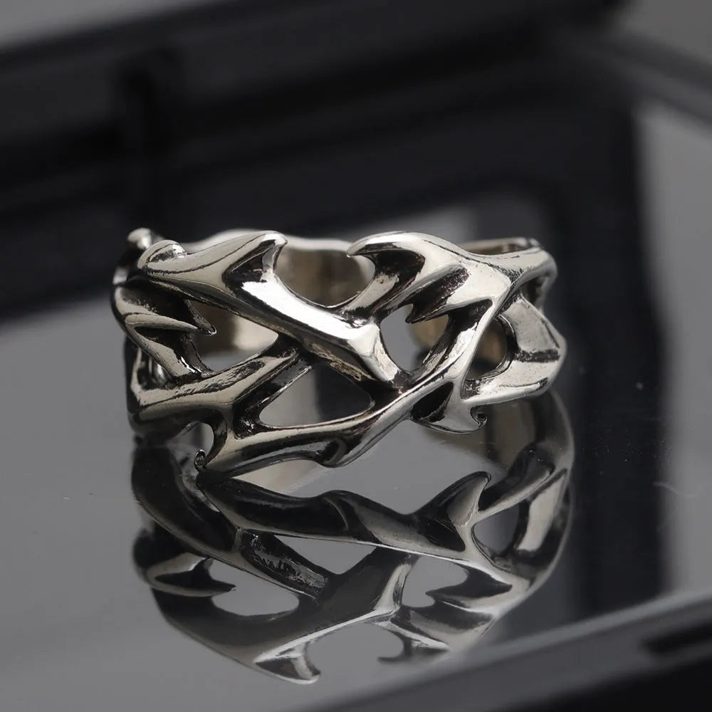 Geometric copper ring with thorn and flower design featuring adjustable opening